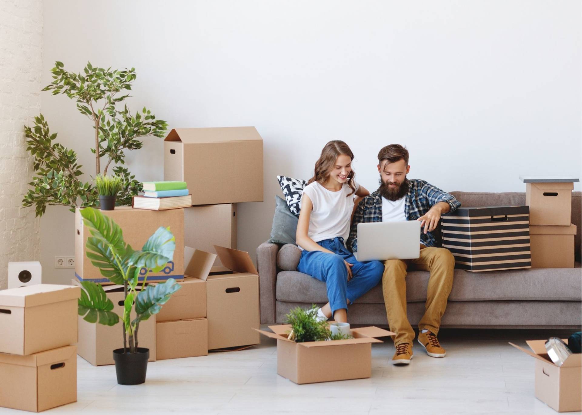 Couple planning their move among boxes